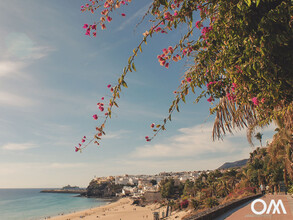 The bay of Morro Jable with cliff, sandy beach and beach promenade