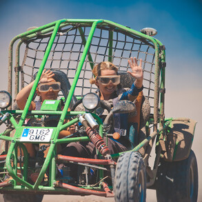 Buggy driving on the dusty gravel roads in the deserted south of Fuerteventura