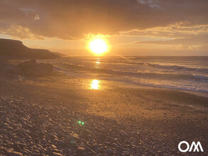 Sunset on an empty beach in winter 2021