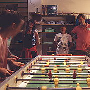 Family with children playing table football