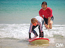 Surf course for families, our surf instructor coaches the kids into the waves