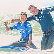 Father and son in the family surf course