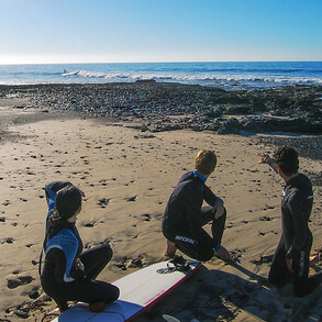 Group of advanced surfers in January at the beach