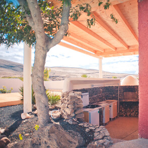 rustic outdoor kitchen with stone oven in the villa in La Pared